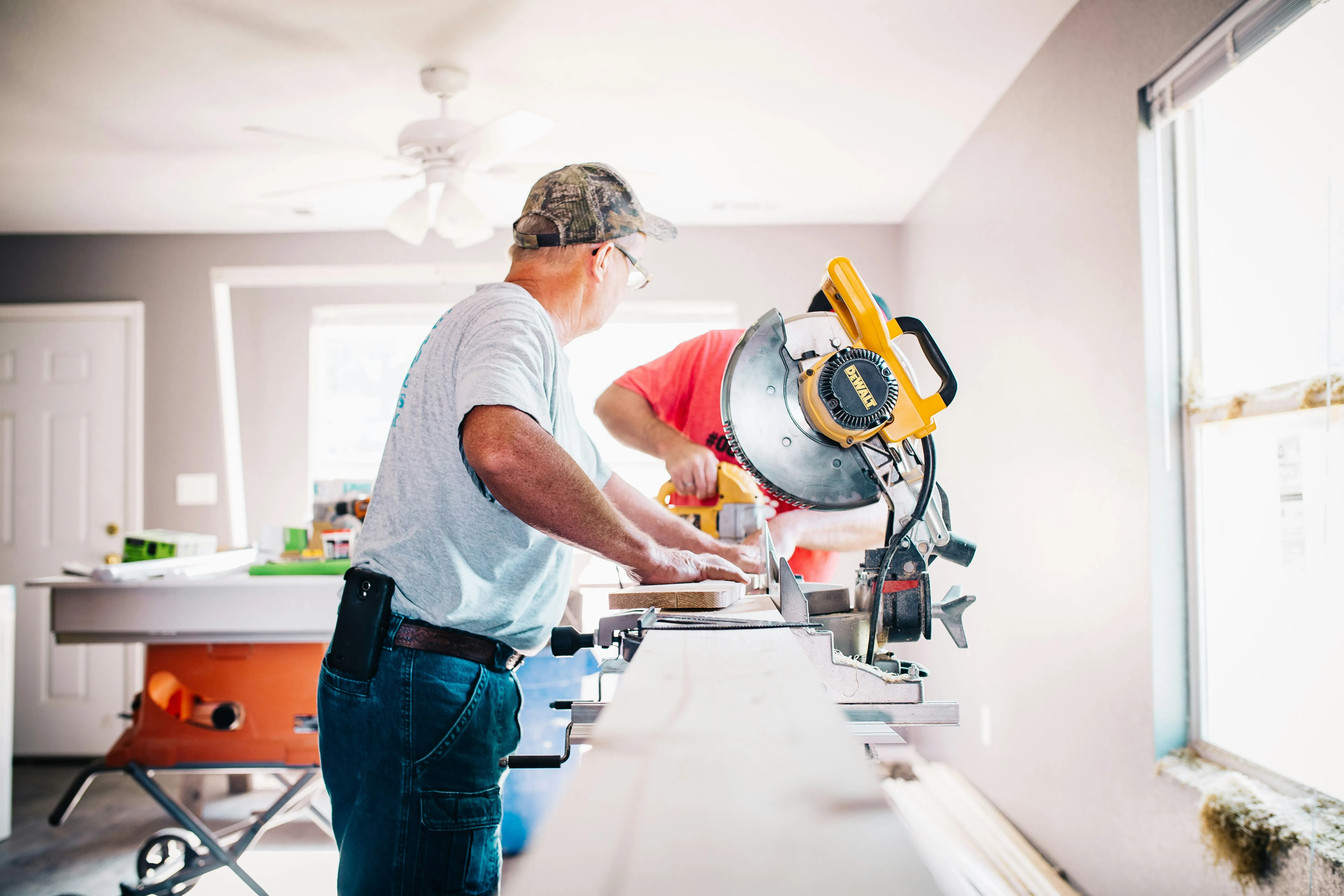 Contractor using a miter saw during property renovation work