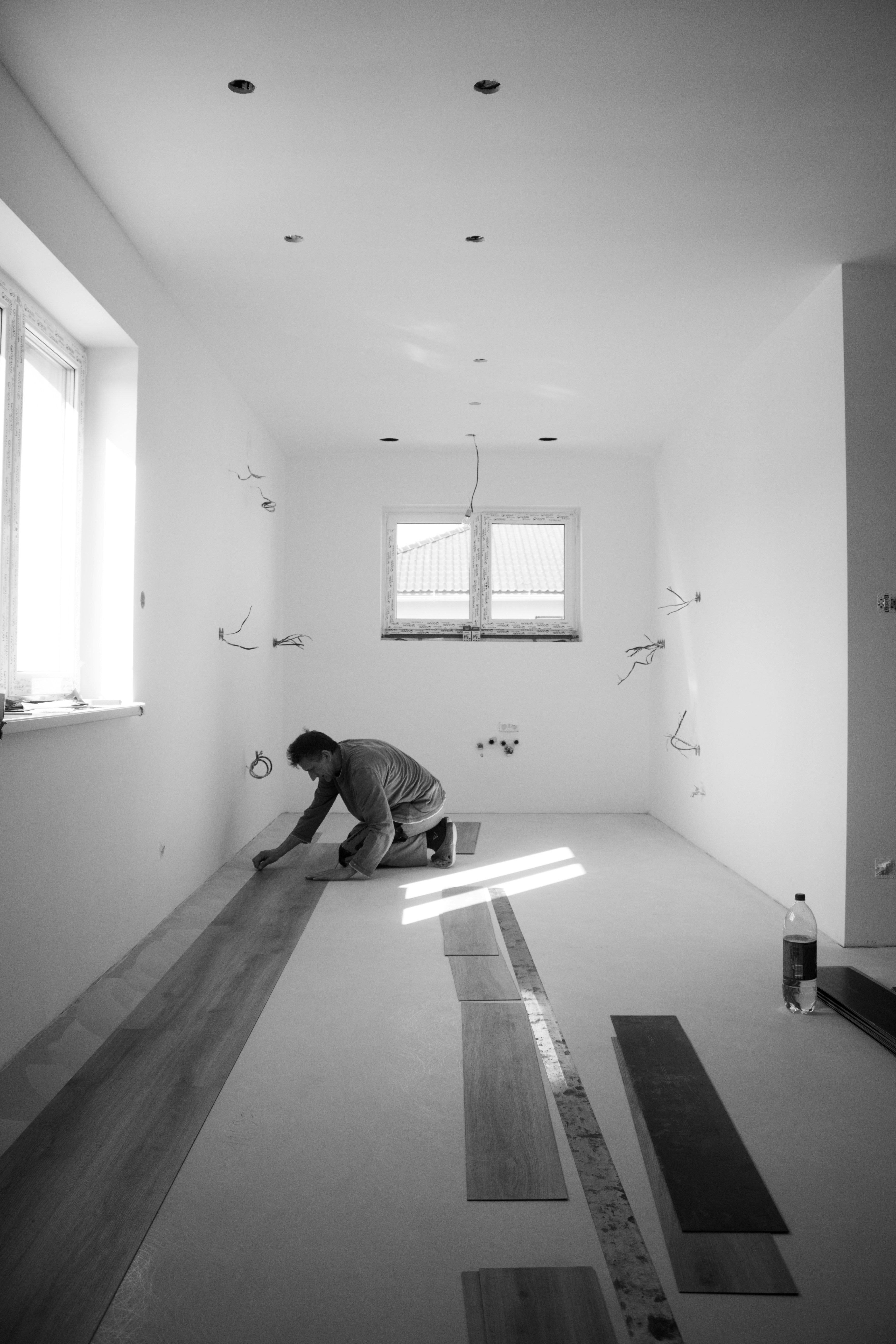 Person carefully installing new flooring in a property renovation