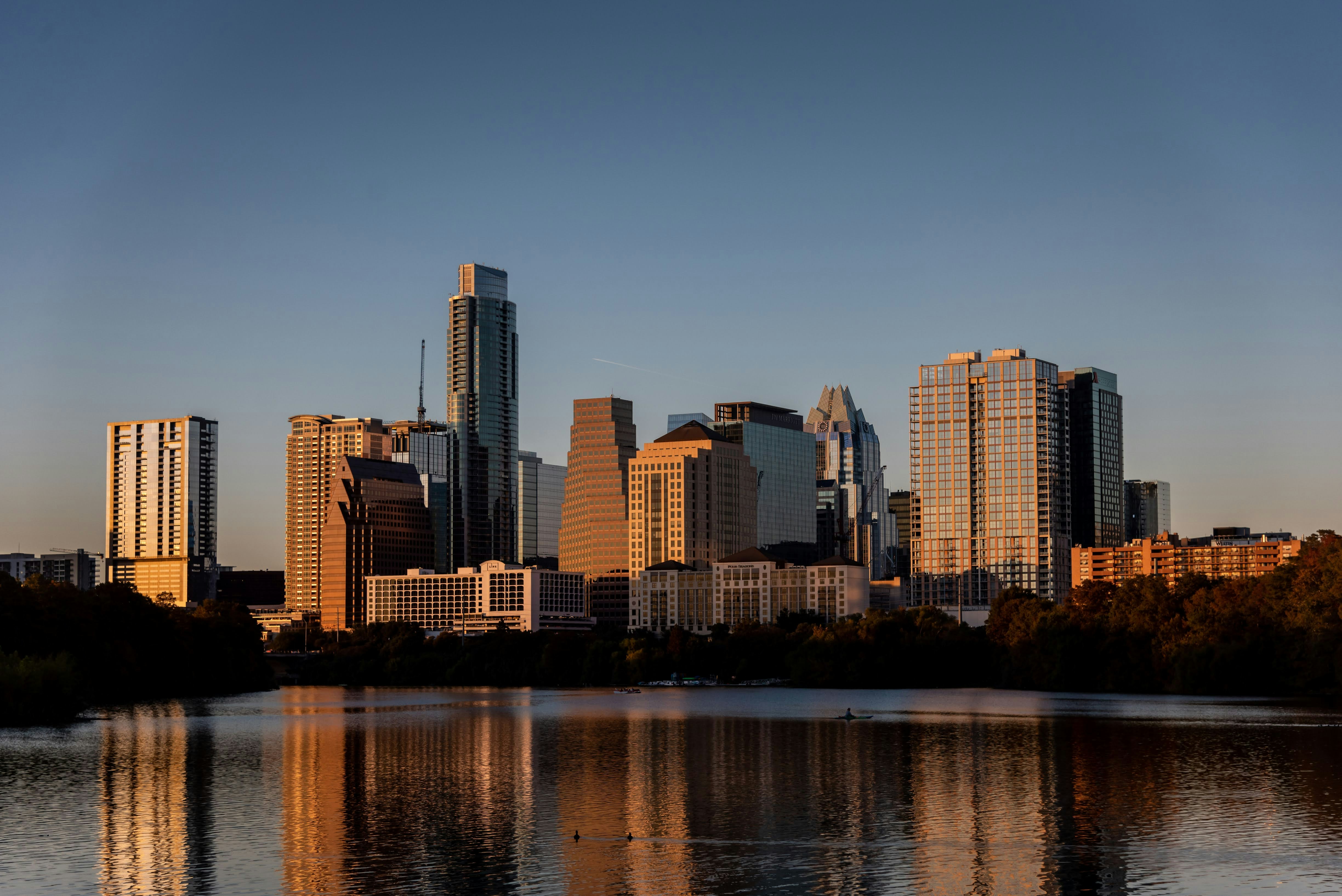 Austin skyline at golden hour reflected in Lady Bird Lake