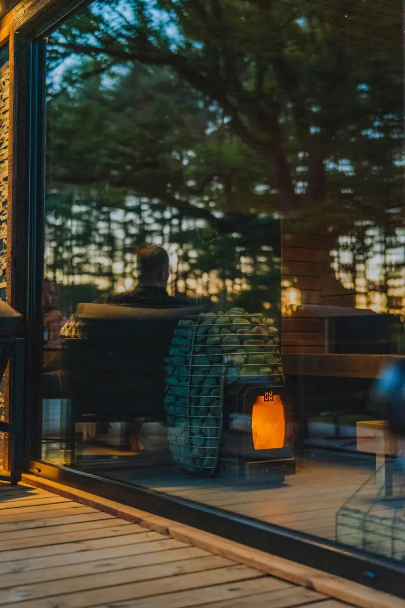 Modern glass office building surrounded by trees