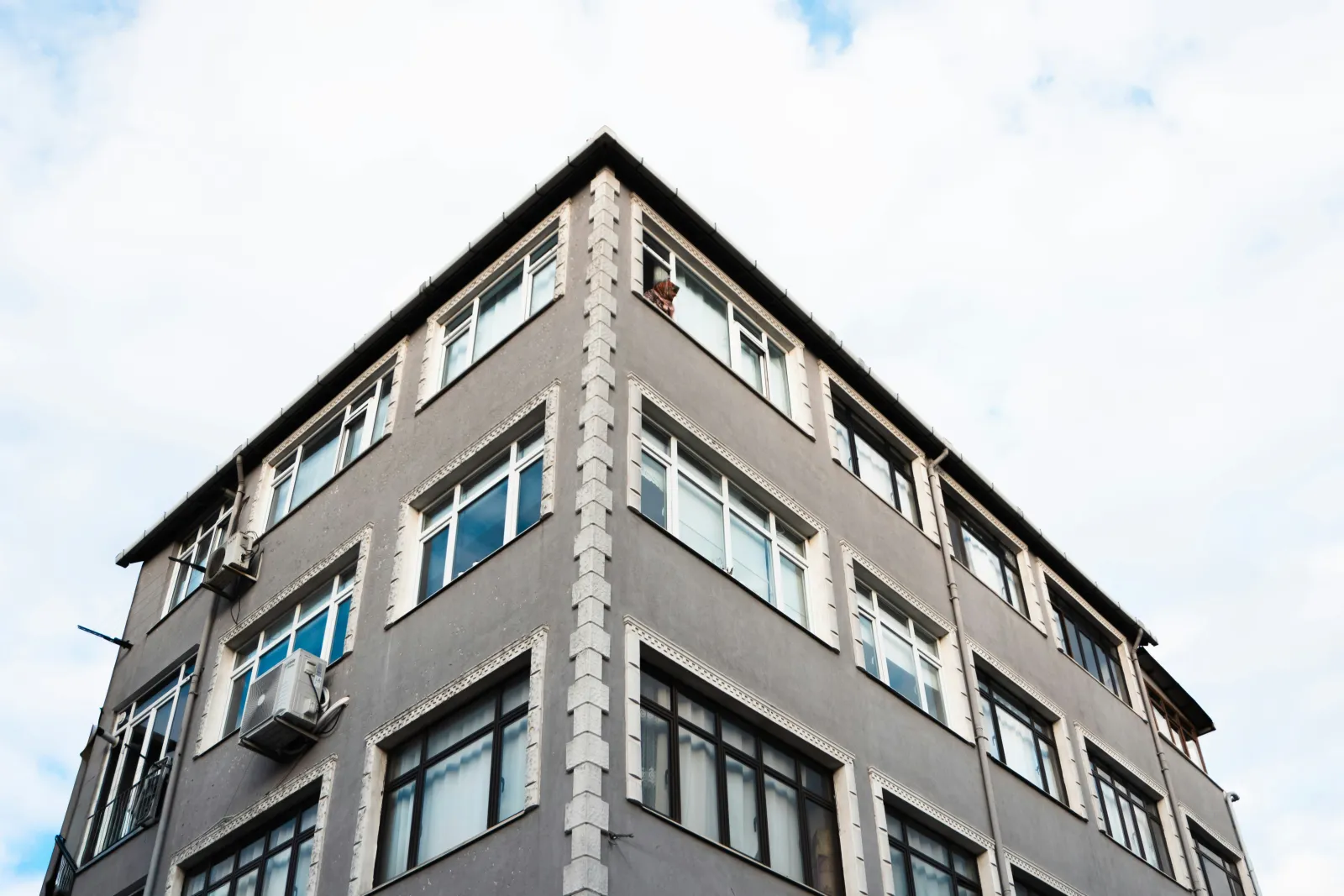 Multifamily building entrance with common area amenities and professional landscaping