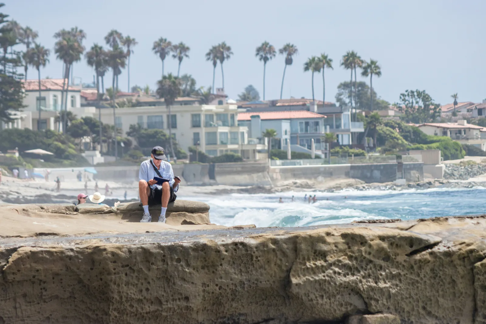 Vacation rental beach house exterior with palm trees and tropical landscaping