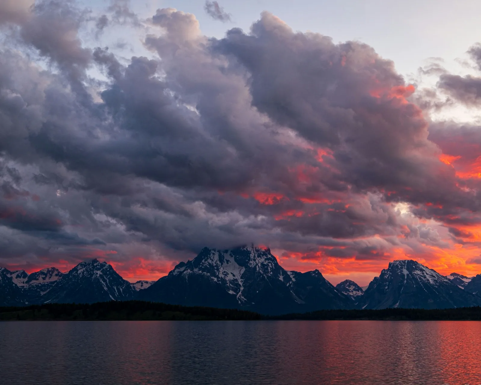 Jackson Hole town and Tetons backdrop with luxury cabin in foreground