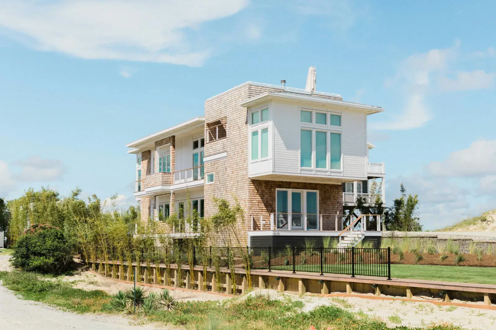 Furnished vacation rental exterior with deck and outdoor seating area